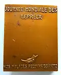 Médaille émise pour la journée mondiale des lépreux, célébrée le dernier dimanche de janvier. Graveur E.J. BELLONI. Verso