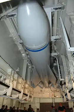 Photo prise par dessous représentant une maquette de bombe MOAB installée dans la soute du B-2.