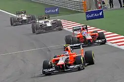 Photo de deux monoplaces Marussia et deux monoplaces HRT à Barheïn