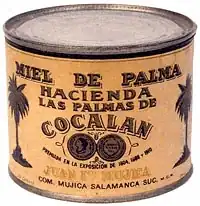 Une boîte alimentaire de conserve de miel de palmier de couleur jaune avec inscriptions et description du produit sur l'emballage.