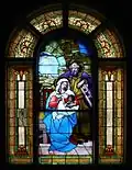 Vitrail de l'entrée représentant la nativité de NSJC