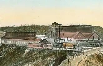 Une usine avec un château d'eau en avant plan.