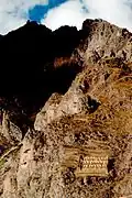 En bas de l'image à gauche, près des Qollqa (ou greniers de l'Inca, à droite) d'Ollantaytambo, les Précolombiens voyaient dans cette roche creusée le profil (plutôt effrayant ici) de l'Inca Pachacutec ou du dieu créateur Viracocha. Une petite construction au sommet figure sa couronne et complète l'image imaginaire.
