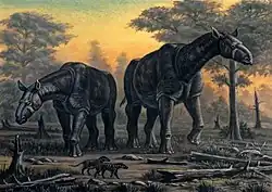 Reconstitution d'un couple de grands mammifères, montré au centre de l'image, avec deux plus petits y figurants en dessous.