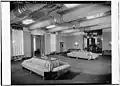 Basement lounge showing stylized couches and benches. Note the bold wall and ceiling designs[Traduire&nbsp;passage]