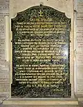 Plaque à l'entrée de la nef.