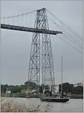 Pen Duick VI remonte la Charente sous le pont du Martrou - Rochefort France, le 17 août 2016.