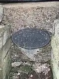 Plaque fixée à la base de la cheminée de Vioménil (Vosges).