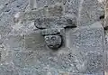 Visage sculpté sur le porche.