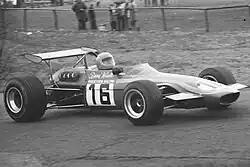 Photographie en noir et blanc d'une Formule 2, vue de trois-quarts, sur une piste, dans son ensemble.