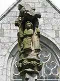 Fontaine-calvaire. Détail. Saint-Jean au pied du Christ en Croix.