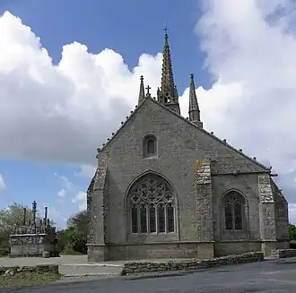 Le chevet (l'ajout du bas-côté se voit par la différence de parement) et le calvaire.
