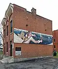À Saint-Jean-sur-Richelieu, une murale sur l'édifice Deland rappelle l'expédition de Champlain sur la rivière des Iroquois en 1609