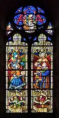 Vitrail des années 1920 par Louis Balmet, représentant les saints Anastase, Marcel, Laurent et Étienne.