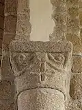 Chapiteau avec croix, volutes et rubans.