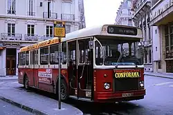 Photographie en couleurs de trois quarts d'un autobus rouge et blanc.