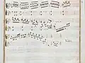 partition manuscrite rehaussée de couleurs passées rouge et vert en bordures