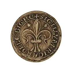 Sceau avec un texte en cercle et au centre une fleur de lys