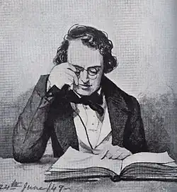 Homme qui ajuste ses lunettes pour lire un livre posé sur une table, il est vêtu d'une veste. Une mention « 24th june 49 » figure écrite en bas à gauche.