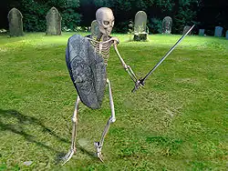 Photo d'un squelette portant une épée et un bouclier