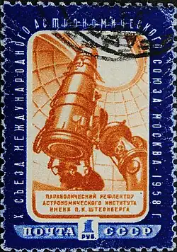 Un gros téléscope, vu en contre-plongée, pointant vers le ciel à travers une coupole ouverte.