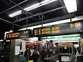 Panneaux d'information avec du texte en orange dans une station de métro à Boston (États-Unis).