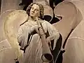 Photographie d'un ange soufflant dans une trompe.