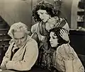 Avec Josef Swickard et Olive Borden (au centre), dans The Eternal Woman (1929, photo promotionnelle)