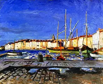 Peinture représentant sous un ciel d'un bleu intense des maisons claires avec devant quelques voiliers et au premier plan un ponton gris