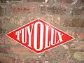 Plaque publicitaire Tuyolux Paris 1957.