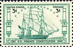 Timbre représentant la Constitution naviguant à la voile vers la droite du timbre.