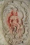 Décor sculpté représentant saint Roch montrant son bubon.