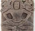 Personnage masculin: yakṣa ? Bas-relief. Trà Kiệu c. VIe&nbsp;siècle. Grès. H0,68 x L0,70 x P0,16&nbsp;cm.Musée de Đà Nẵng
