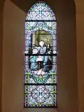 Vitrail à gauche du retable