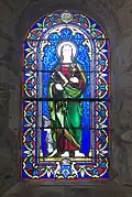 Vitrail de l'église Notre-Dame de Veyries (Labastide-Castel-Amouroux). Offert par la famille Canelle de Lalobbe (blason en pied), fabriqué par la manufacture de vitraux Gesta (cartouche en tête). Saint non identifié.