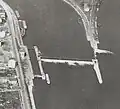 Photographie aérienne orientée au nord, avec l'ancien barrage de la Mulatière en 1935