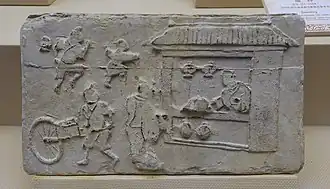 Brique murale funéraire de la période Han, une brouette est représentée.