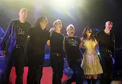 Photo en couleur d'un groupe de six personnes se tenant les uns les autres