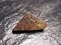 Météorite de Zakłodzie&nbsp;(en), une achondrite primitive non groupée. Masse : 1,08&nbsp;g.
