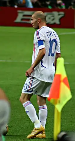 Portrait, de 3/4, d'un joueur de football portant un millot blanc et le numéro 10
